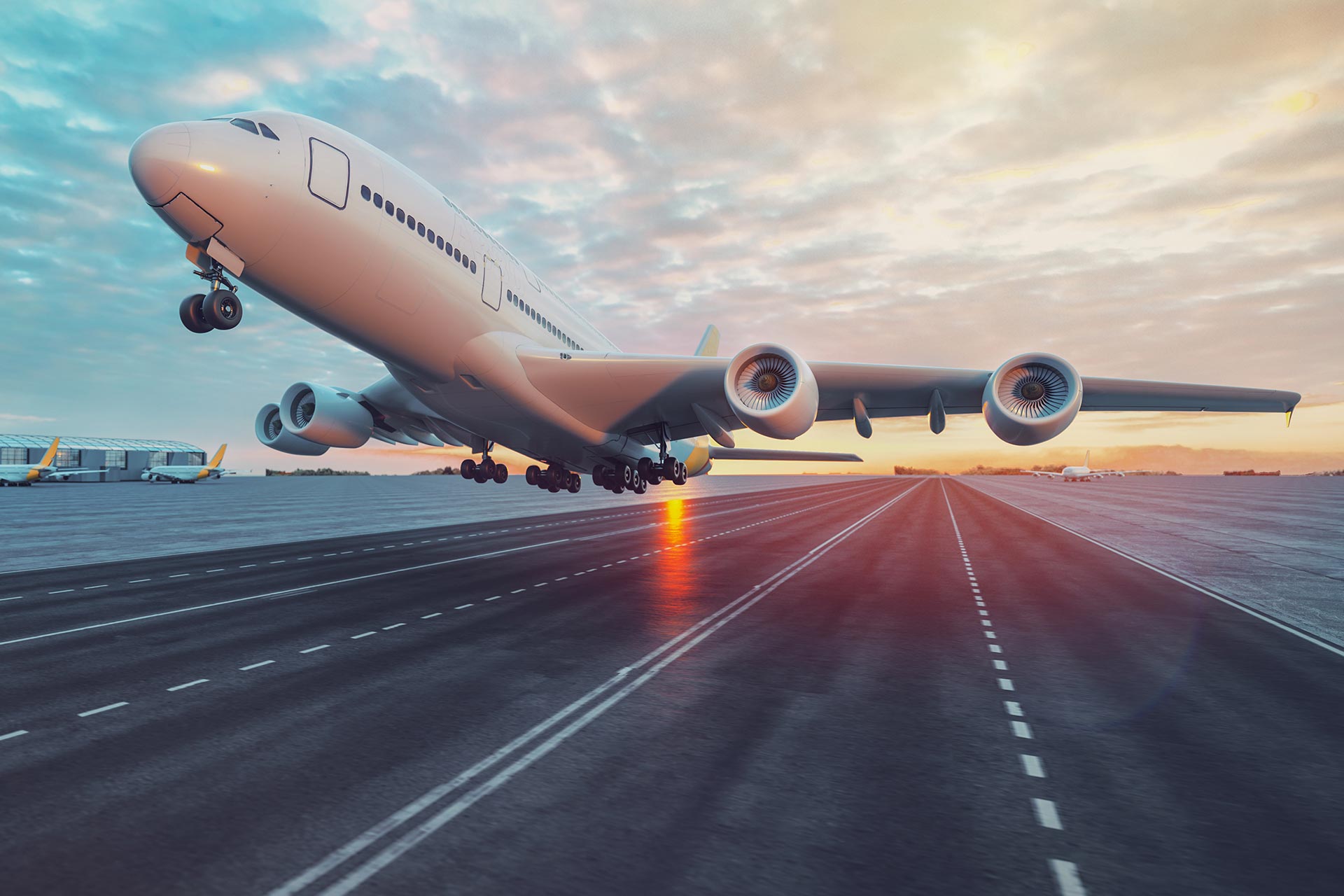 Cargo plane taking off at sunset